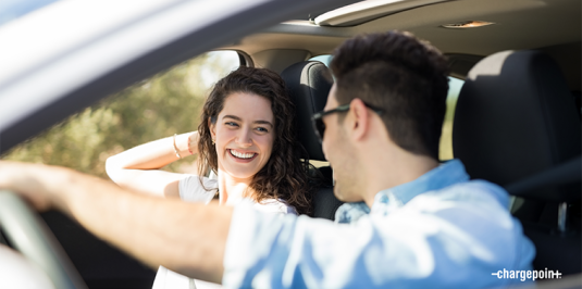 Happy couple in an EV